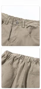 Detailed view of khaki trousers featuring elastic waistband and metal button closure