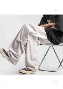 Detail view of light grey quick-dry tactical parachute pants with crinkled texture fabric