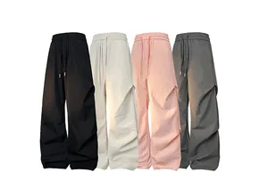 Flat lay of quick-dry cargo pants in black, beige, pink and grey with pleated texture