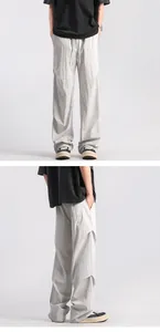 Detail of light gray wide-leg trousers with elastic drawstring waist and pleated fabric