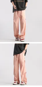 Detailed macro view of light pink pleated parachute pants with drawstring waist