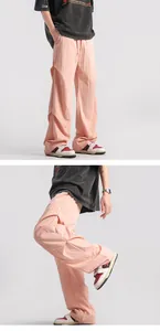 Macro detail of pink parachute pants with pleats, drawstring waist and 3D panel design