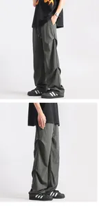 Detail view of American utility cargo pants featuring side pleats and lightweight fabric