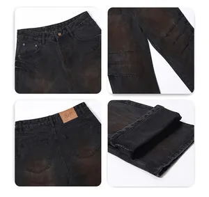 Dettaglio dei jeans grigi con lavaggio ruggine ed effetto invecchiato con strappi