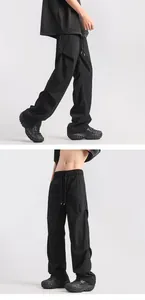 Macro detail of black pleated cargo pants featuring drawstring waist and lightweight fabric