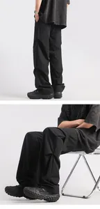 Detailed view of men's black loose cargo pants showing textured quick-dry fabric and fit