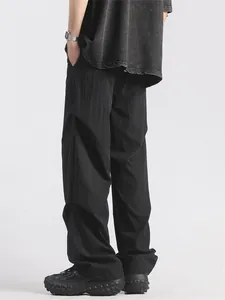 Men's loose black cargo pants with water-resistant fabric and casual pleated design