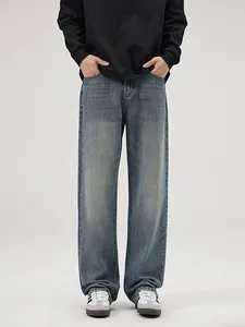 Men's retro heavy washed straight leg denim jeans in a loose mid-blue vintage fit