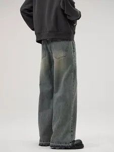 Jean large rétro pour homme avec ourlet brut et délavage vintage en bleu-gris usé