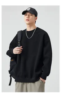 Close-up of oversized black crewneck sweatshirt with ribbed cuffs and street style details