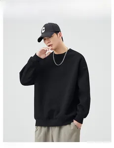 Detailed view of casual black crewneck sweatshirt with dropped shoulders on a male model