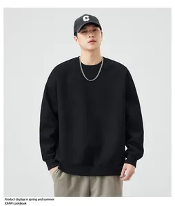 Detail of heavyweight black crewneck sweatshirt with ribbed cuffs and drop shoulder seam