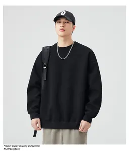 Detail of black crewneck sweatshirt featuring dropped shoulders and ribbed cuffs