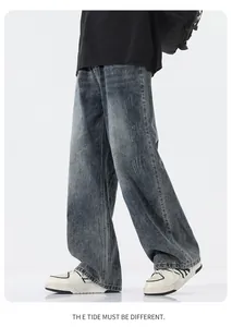 Detail of grey washed wide-leg denim pants showing vintage texture and loose street fit