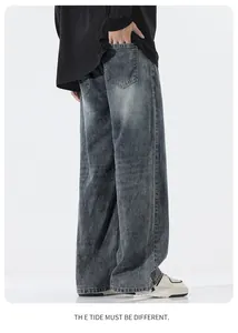 Detail showing the heavy washed denim texture and snow-point effect on loose jeans
