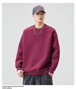 Detailed close-up of heavyweight wine red crewneck sweatshirt with ribbed cuffs and hem