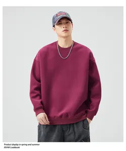 Detail view of burgundy oversized crewneck sweatshirt with ribbed cuffs and drop shoulder