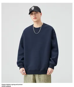 Detail of navy blue crew neck sweatshirt featuring ribbed cuffs and a relaxed drop shoulder fit