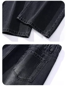 Close-up of double-stitched hems and pentagonal back pockets on vintage grey denim pants