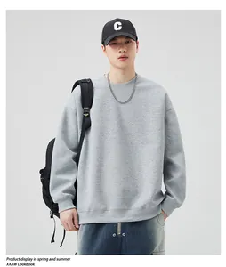 Close-up of a grey crewneck sweatshirt with dropped shoulders and high-quality cotton texture