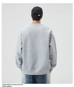 Rear view of a light grey oversized sweatshirt with ribbed cuffs and loose fit