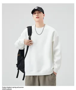 Detailed view of white crewneck sweatshirt with ribbed cuffs and drop shoulder fit