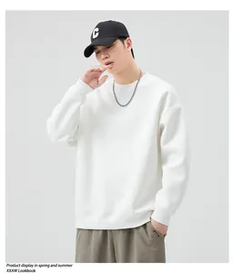 Detail of a white crewneck sweatshirt with relaxed shoulders and minimalist style