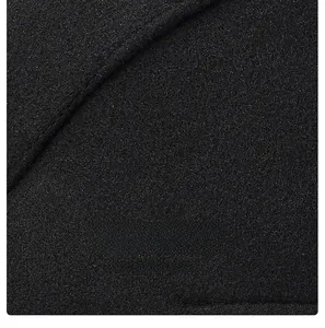 Detail shot of neat edge stitching and texture on a black wool winter ivy flat cap