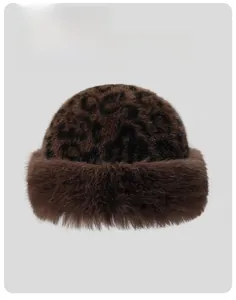 Detail view of winter leopard faux fur hat showing plush texture and brown thick brim