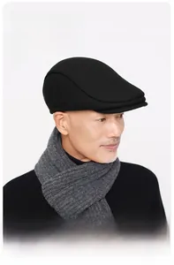 Detailed close-up showing the structured brim and thick wool texture of the black winter cap