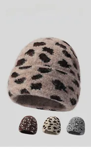 Detailed view of the fuzzy leopard print beanie texture with plush knit faux mink fur