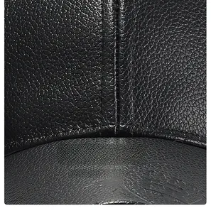 Macro detail of the premium black lychee texture PU leather with precise vertical stitching