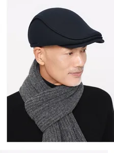 Close-up of navy wool flat cap with grey knit scarf for winter outdoor warmth
