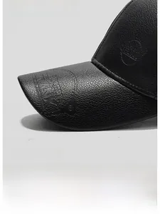 Close-up of black PU leather baseball cap with textured litchi grain and embossed logo