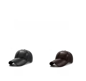 Close-up of textured faux leather baseball caps in black and brown with embossed brims