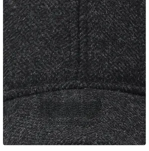 Macro detail of high-quality wool fabric and reinforced stitching on a warm baseball cap
