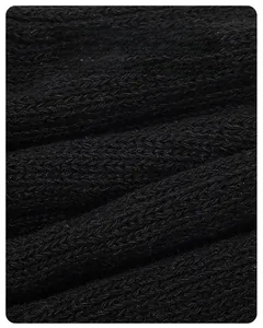 Close-up of black chunky knit fabric texture showing high-quality thermal insulation