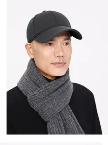 Detail of wool baseball cap and ribbed knit scarf set for men in winter grey tones