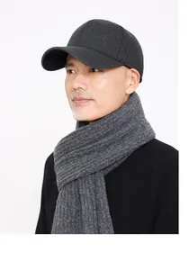 Close-up of wool baseball cap and matching thick knit scarf set in charcoal gray