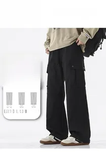 Detail of men's black cargo pants featuring functional flap pockets and loose fit