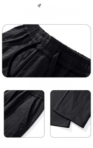Detail view of elastic drawstring waist and side pockets on black outdoor cargo pants