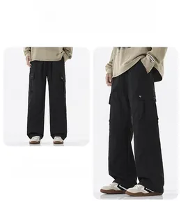 Detail of black tactical cargo pants showing side pockets and loose straight leg cut