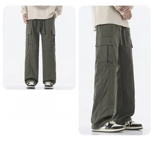 Detail view of olive green cargo pants featuring large utility pockets and drawstring waist