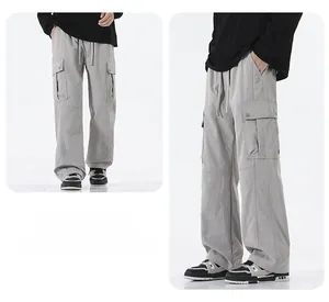Detail view of men's gray outdoor cargo pants featuring waterproof fabric and side pockets