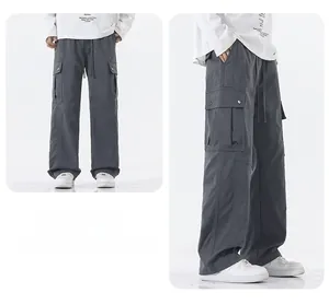 Macro detail of charcoal grey cargo pants featuring snap-button pockets and drawstring waist