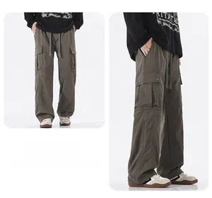 Detail view of men's loose cargo pants with large side pockets and drawstring waist