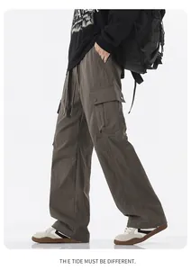 Detail view of khaki waterproof cargo pants with spacious side flap pockets and straight fit