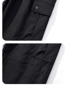 Detail shot of black outdoor tactical cargo pants with reinforced pockets and snaps