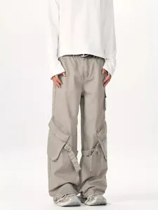 Neutral baggy multi-pocket cargo pants in light taupe with ribbons and metal buckles