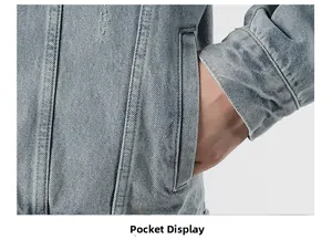 Detailed close-up showing the side pocket stitching on this light blue denim jacket